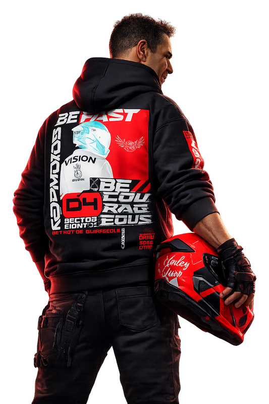 Motorcycle rider wearing black motorsport hoodie with bold red back graphic, holding helmet, photographed from behind in dark studio, aggressive street racing and performance-driven lifestyle.